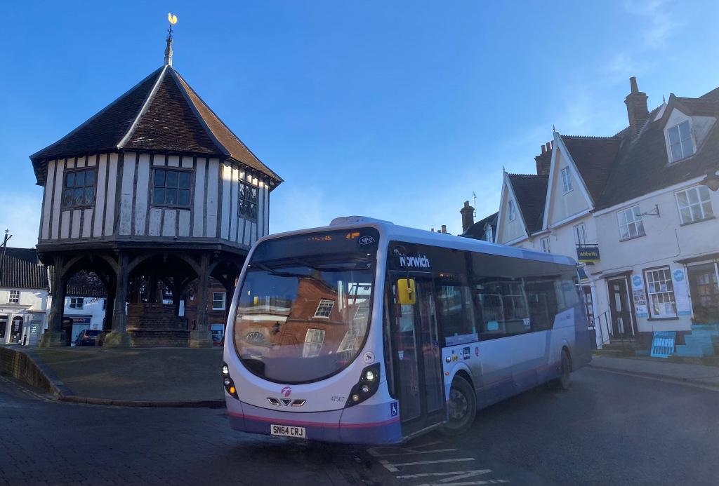 A single decker bus in front of Wymondham Cross