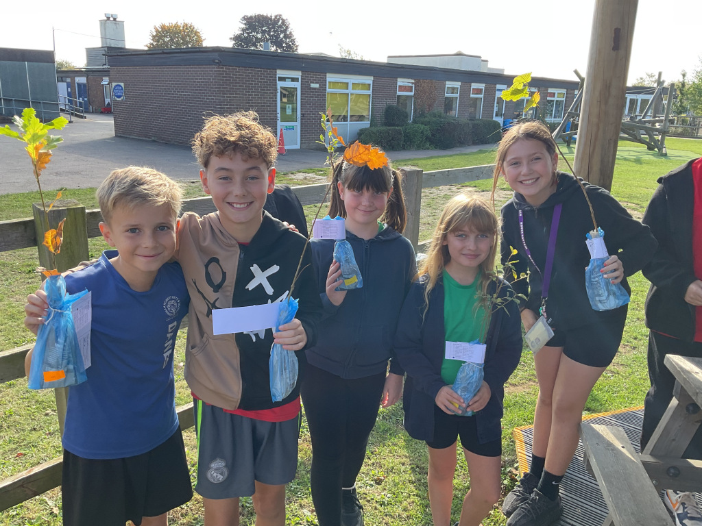 Schoolchildren posing with plants