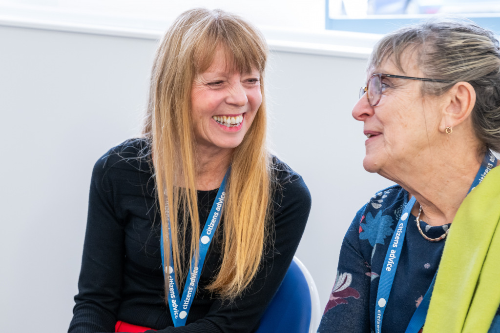 Two women smiling in conversation