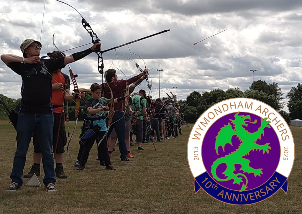 Archers shooting arrows with the Wymondham Archers 10th Anniversary logo in the bottom right corner