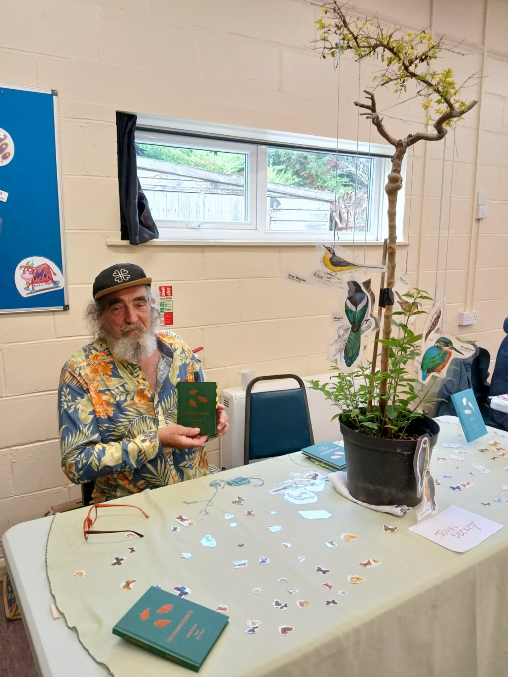 Man sitting at a table with a plant