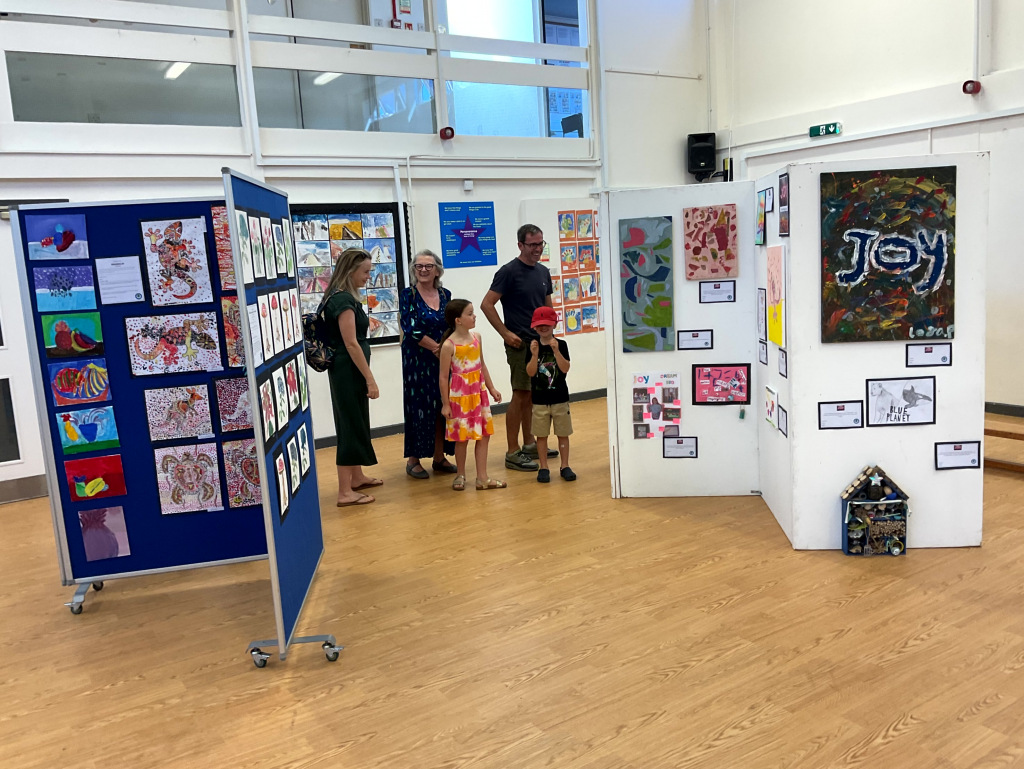 People looking at a school art display