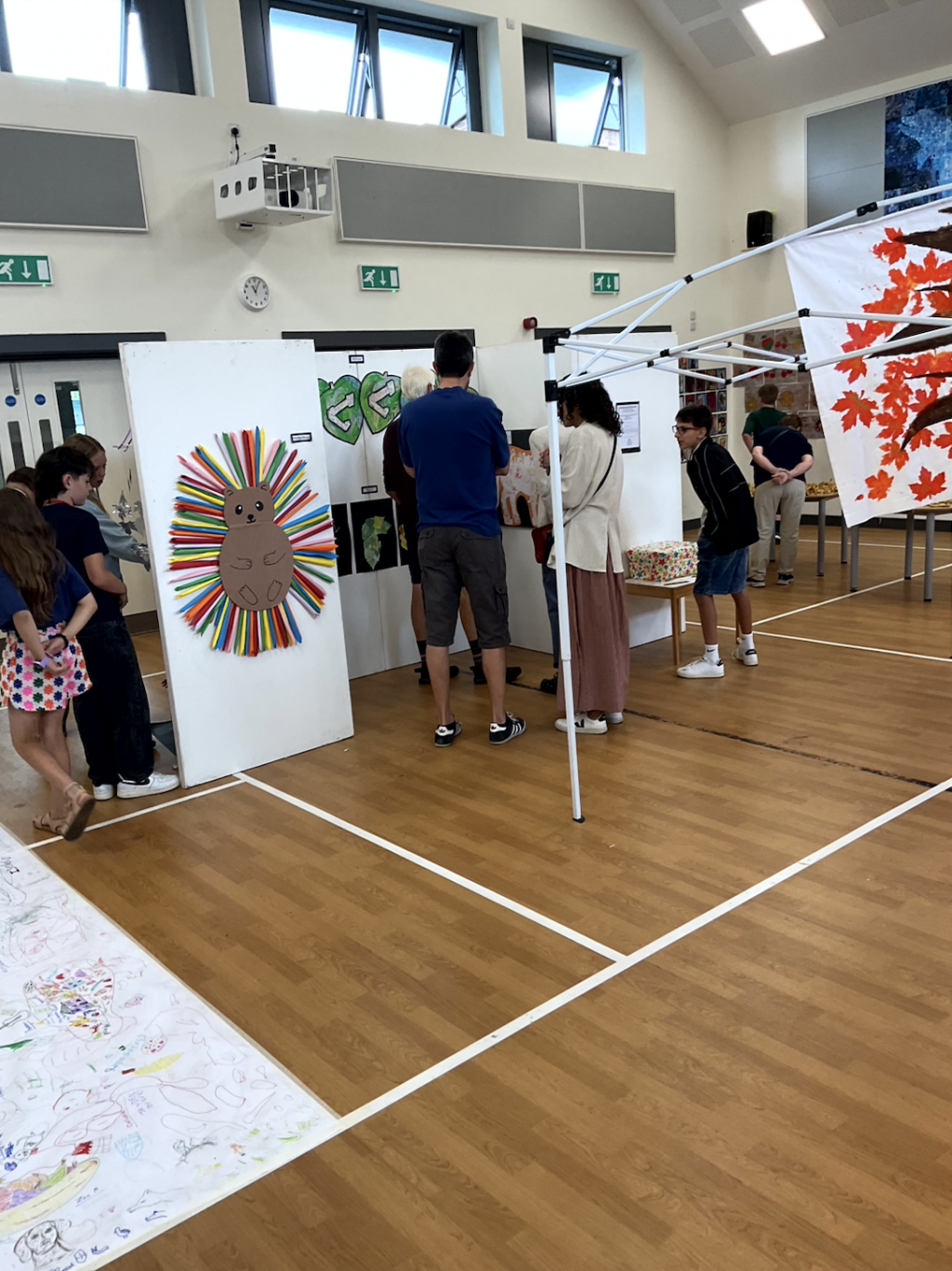 People looking at a school art display