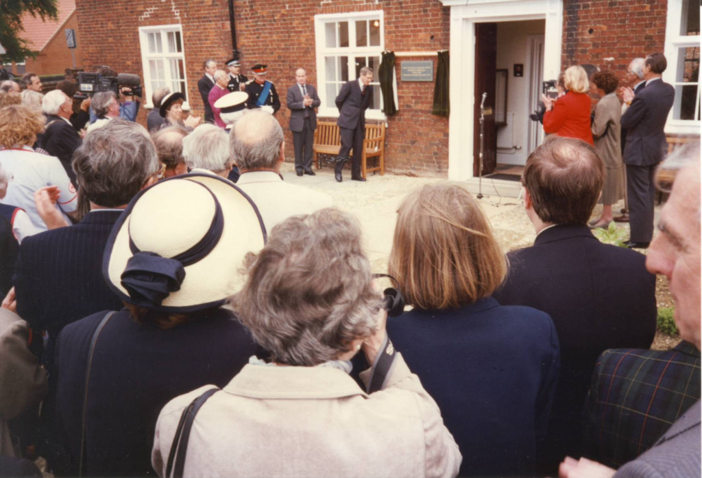People crowding around the door to a building