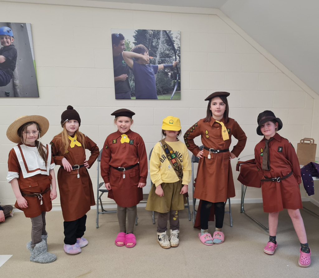 Girls dressed in old brownie uniforms