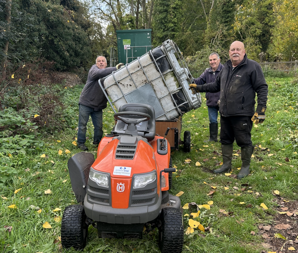 Men standing by a storage vehicle