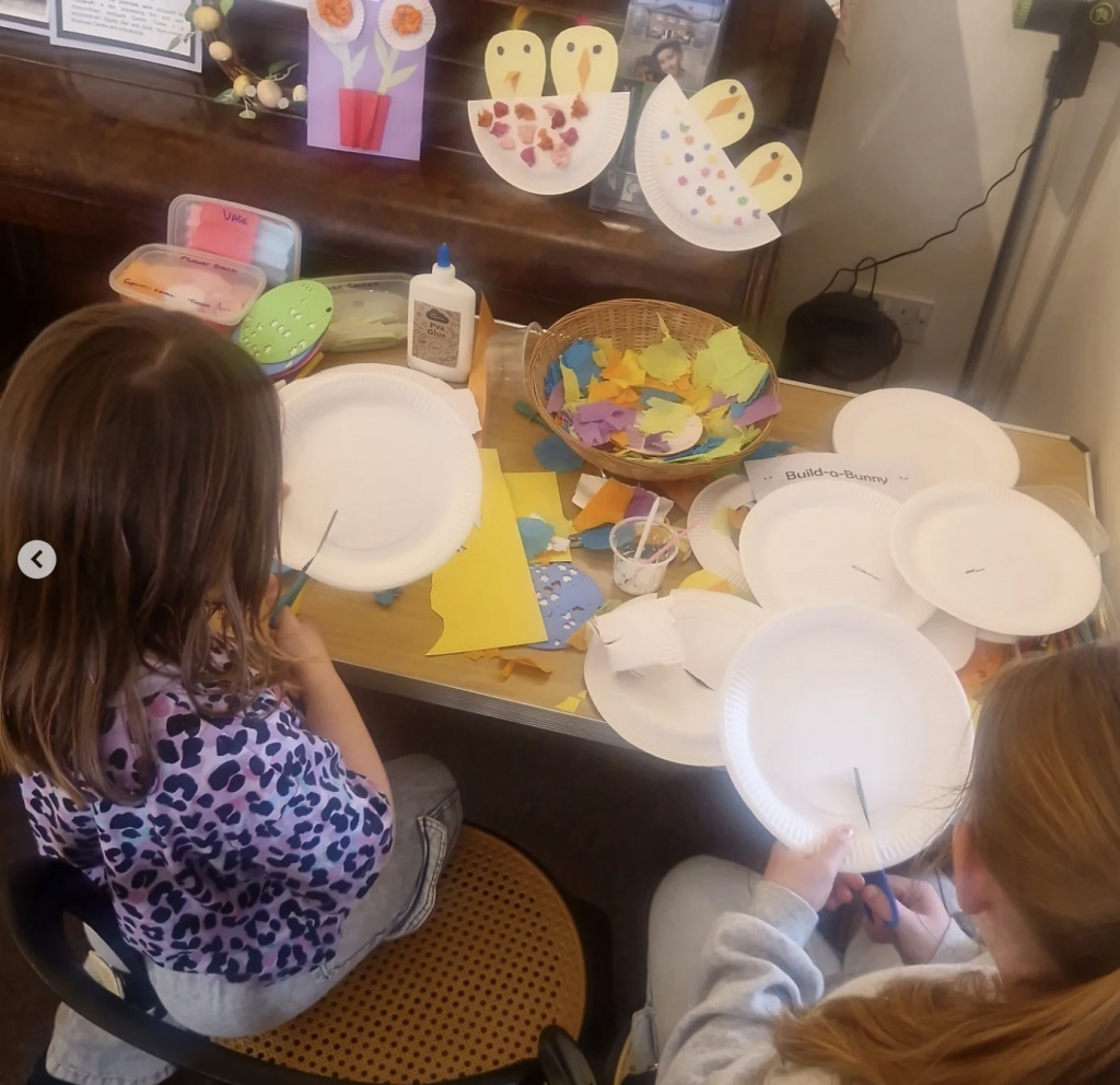 Two girls painting paper plates