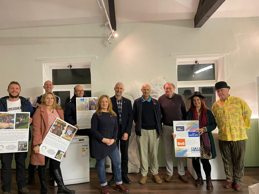 Photo of several people celebrating donation of white goods