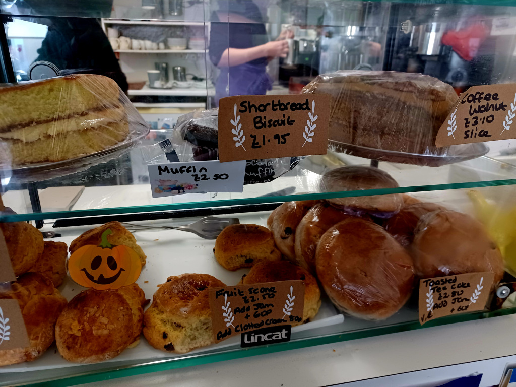 Croissants and cakes on a cafe stand