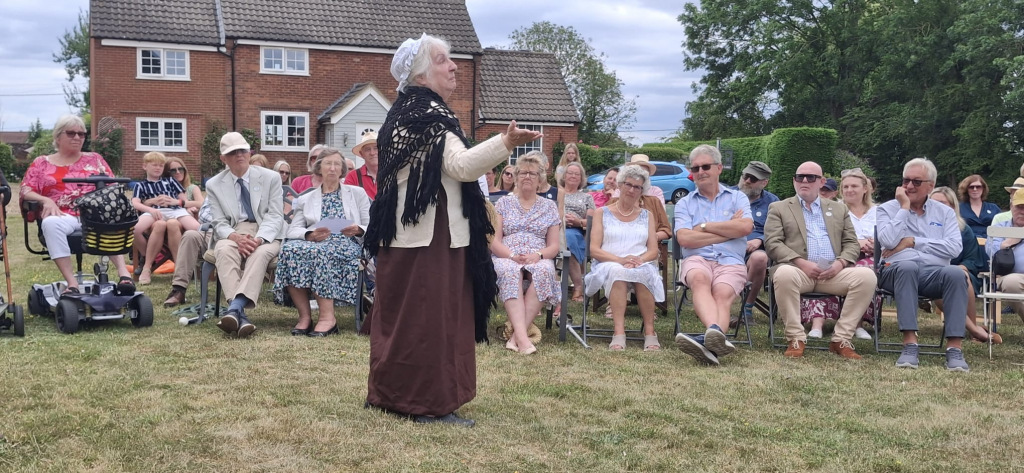 Woman in costume performing to a crowd
