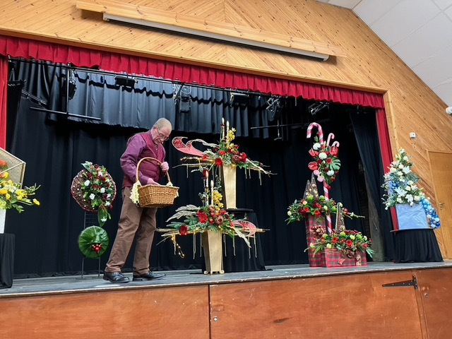 Man onstage with flowers