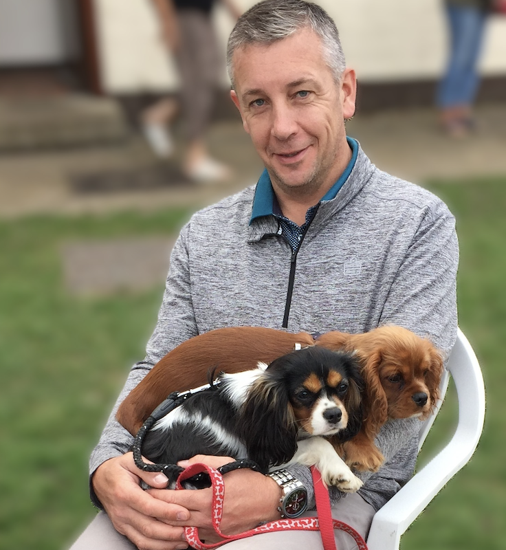 A man with two dogs