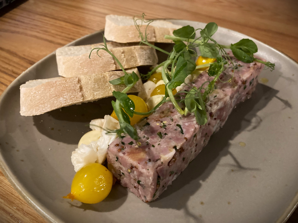 Terrine with cress garnish and side of sliced bread