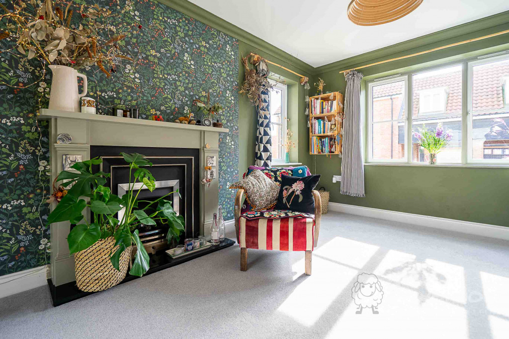 Lounge with green walls and fireplace