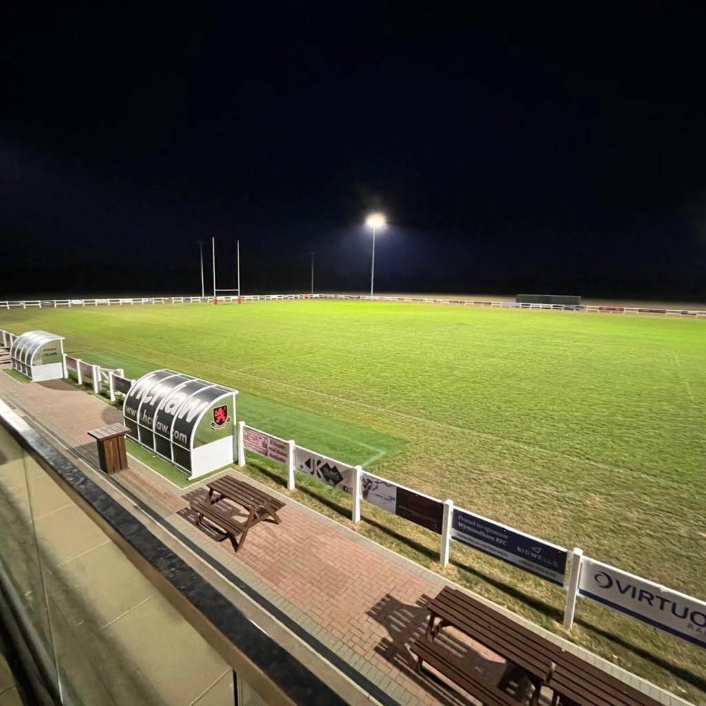 A lit-up-at-night green rugby court