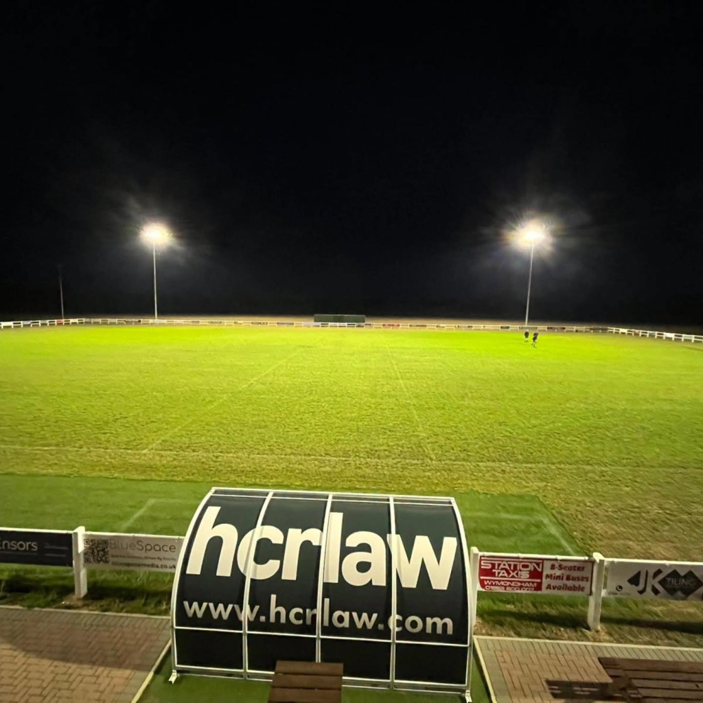 A lit-up-at-night green rugby court