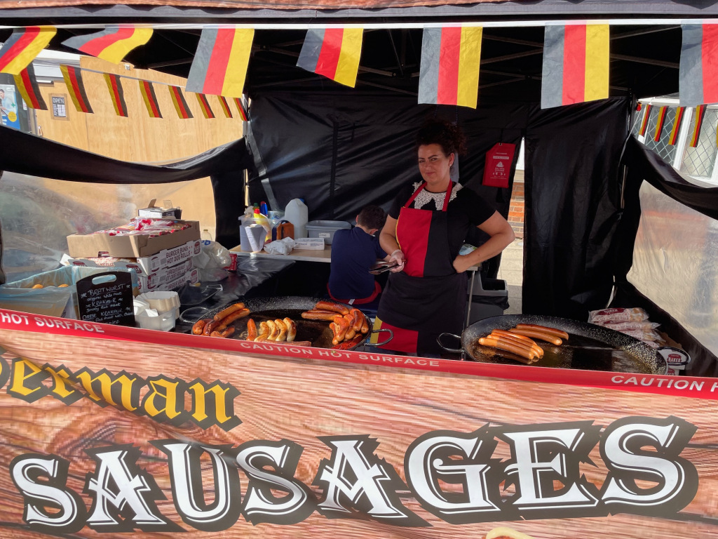 Woman selling sausages on festival stall