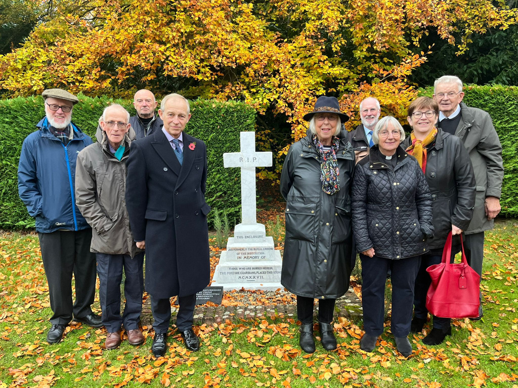 Group of people standing by a cross