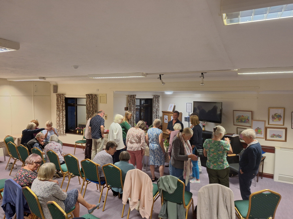 People milling in a presentation room