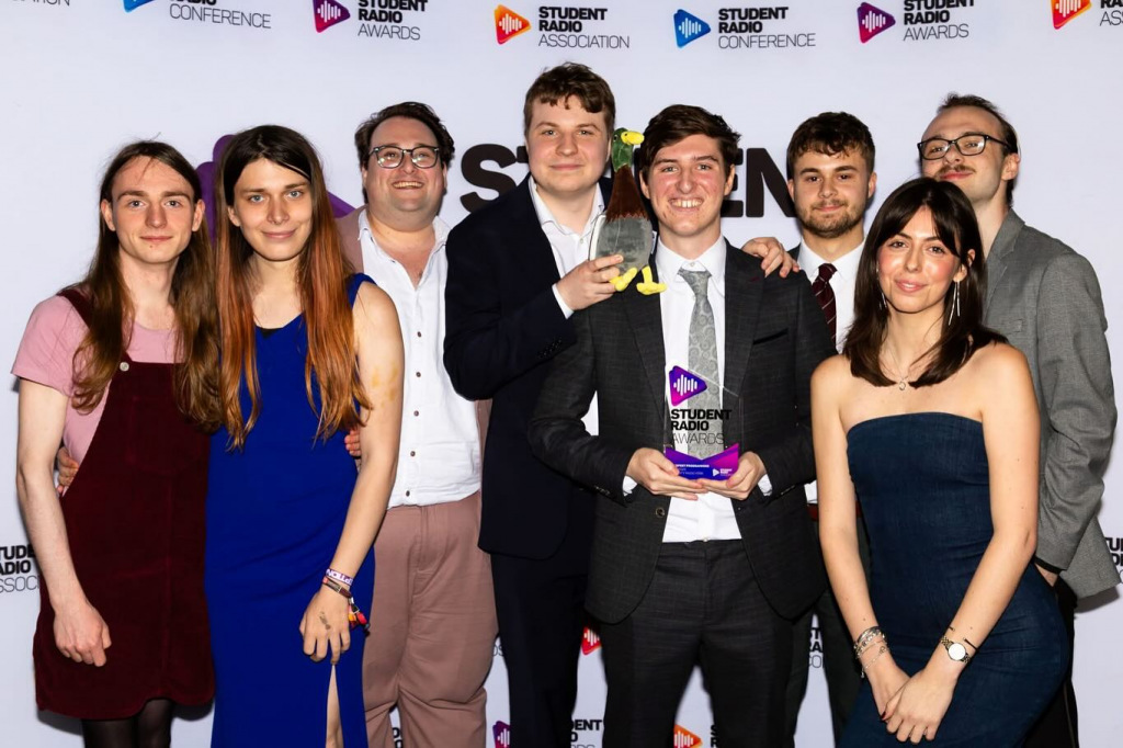 A group of people holding an award