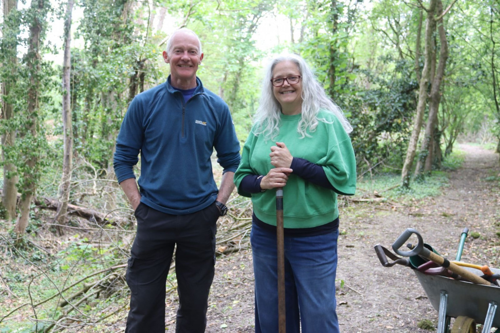 Two people standing in a wood
