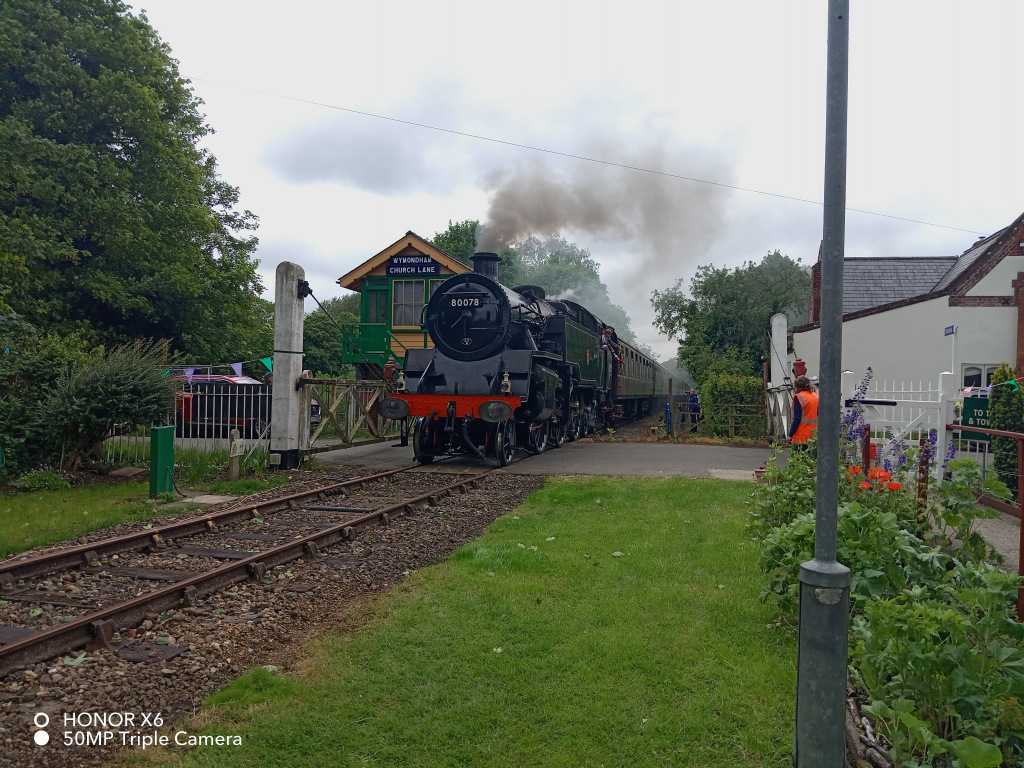 Steam train pulling into a station