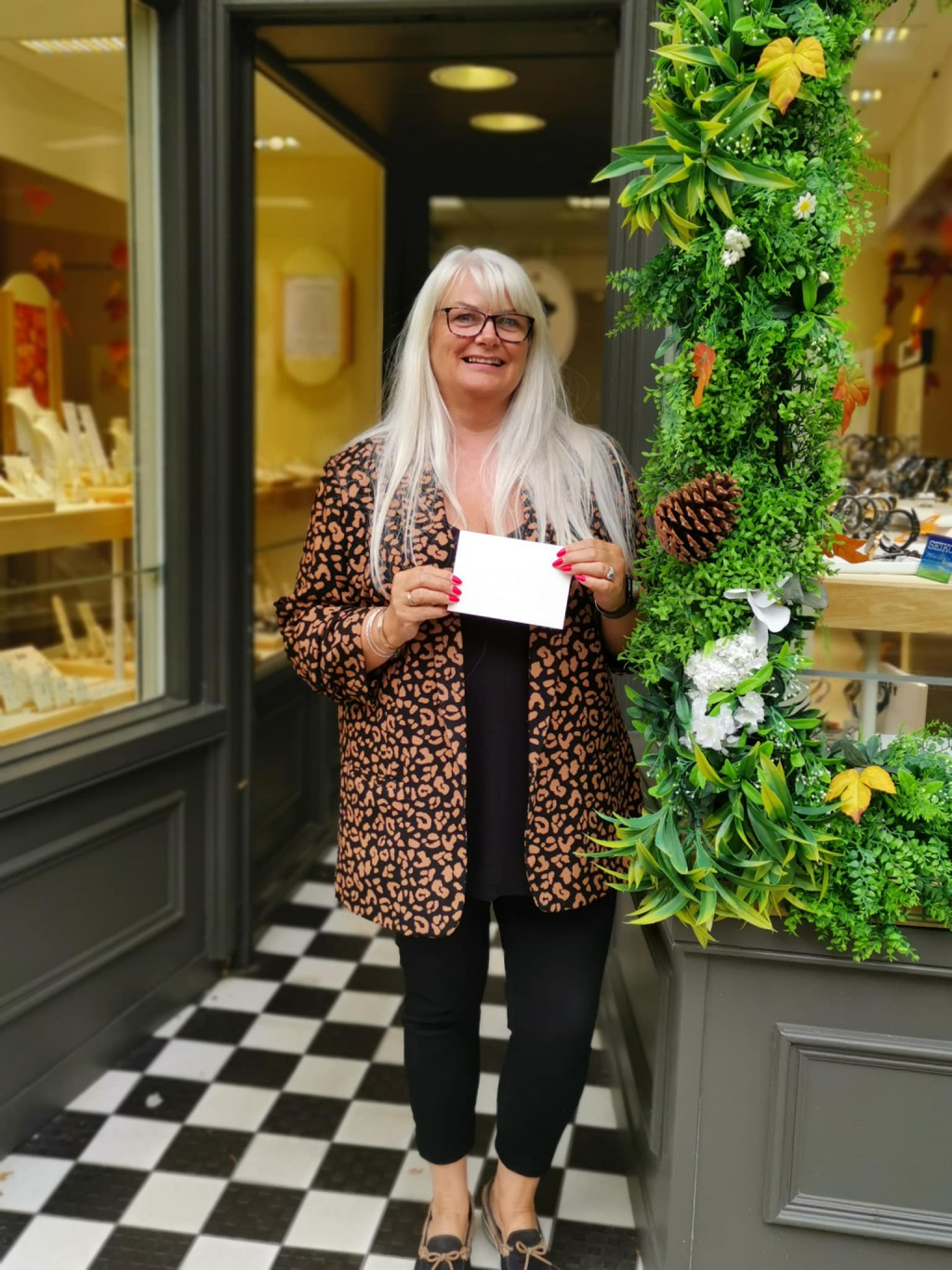 A lady in front of a shop