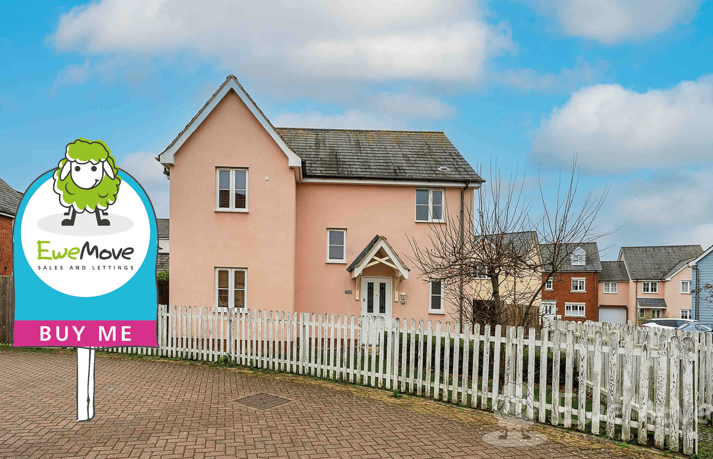 Photo of a pink house with white picket fence