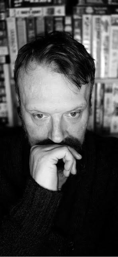 A black-and-white still of a man