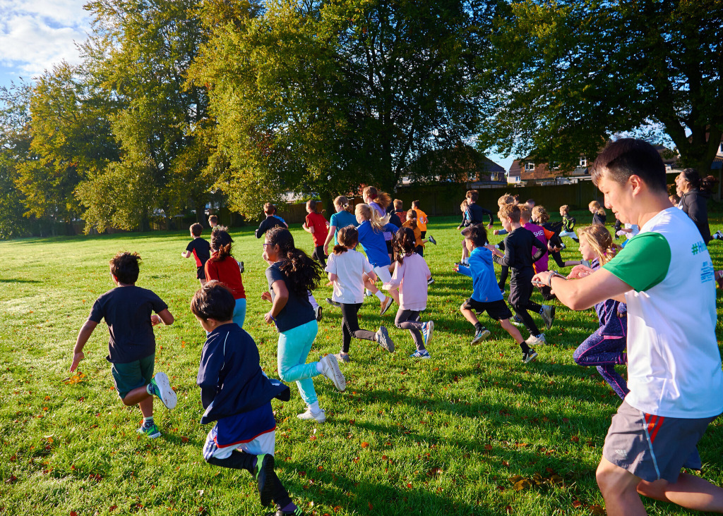 Children running along grass