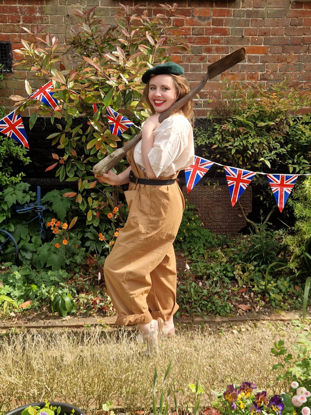 Woman holding a spade in WWII-like fancy dress