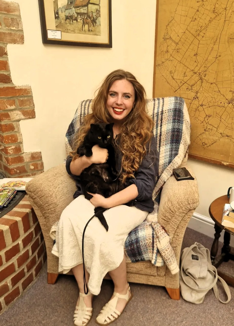 Woman in a chair holding a cat