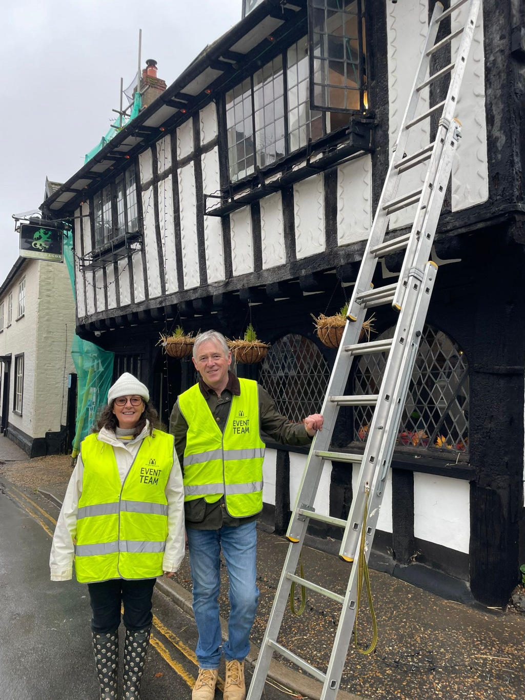 People hanging Christmas lights