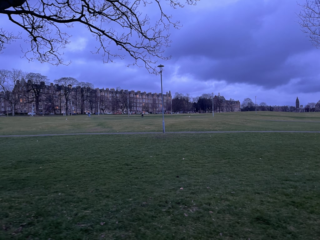 A playing field with a building in the background