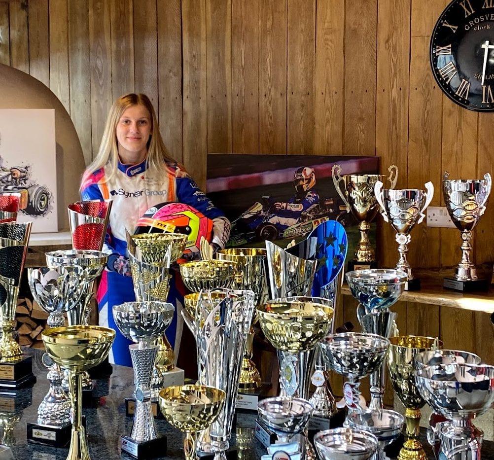 Macie in room full of trophies