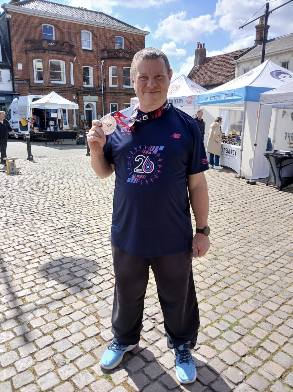 Man holding a medal around his neck