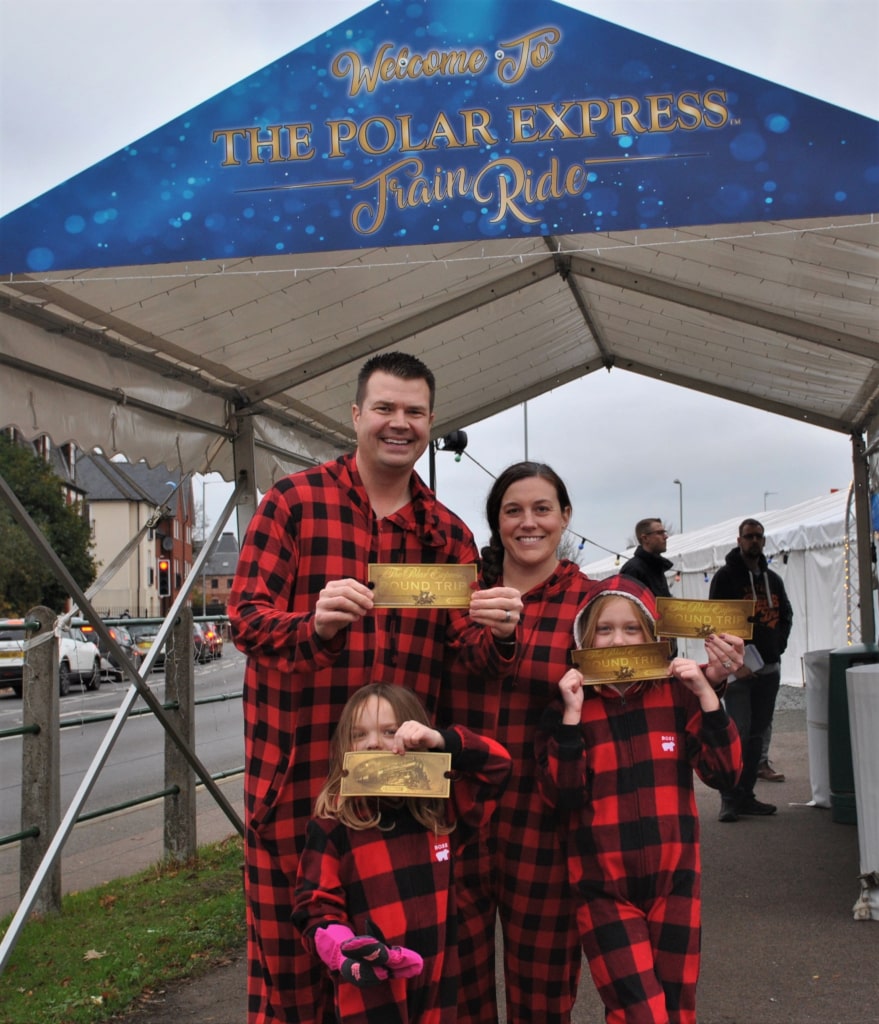 Polar express attendees in fancy dress with tickets