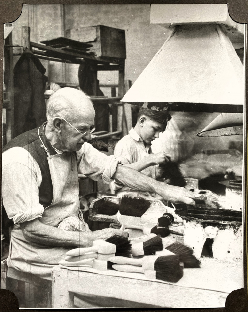 Two men make brushes in factory in 1948