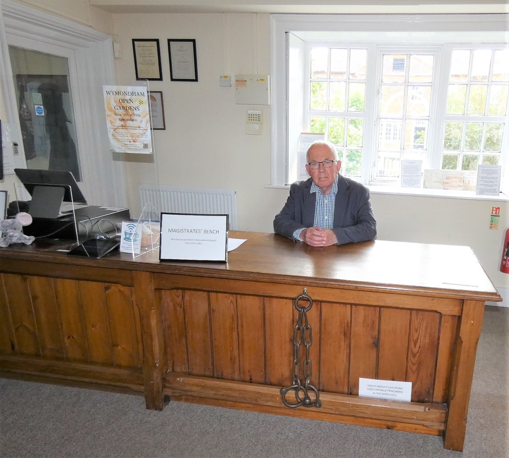 William Armstrong sits behind original Magistrate's bench