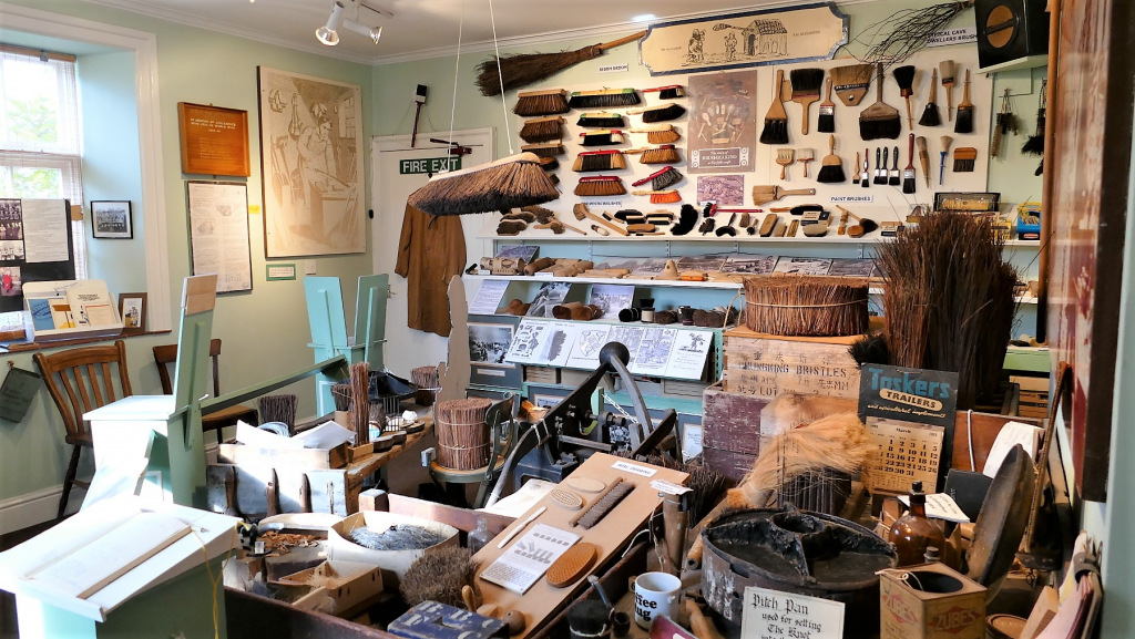 Interior of museum room with old brushes on display