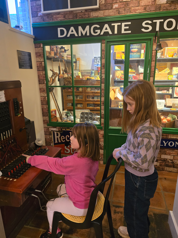 Kids playing with old switchboard in museum