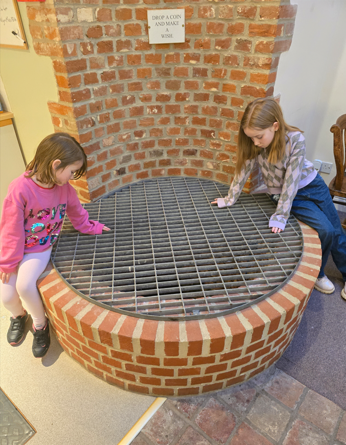 Kids looking into wishing well