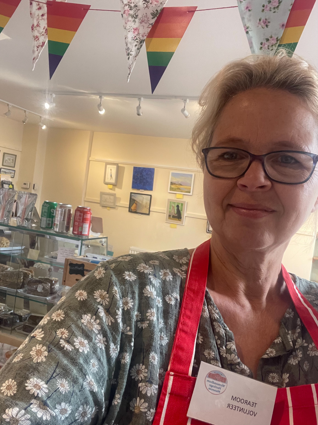 Woman taking a selfie wearing a volunteers' apron