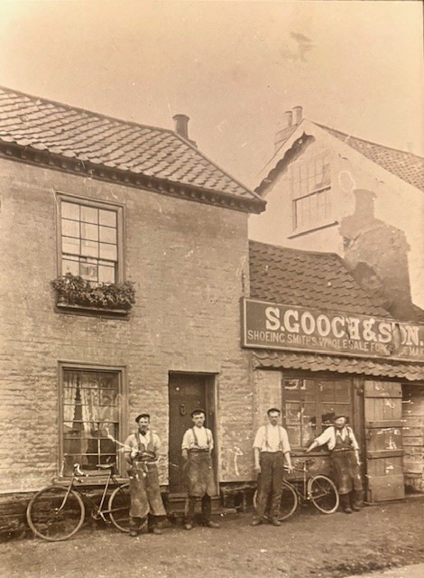 Sepiatone photo of a street with a shop front