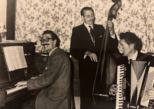 Sepia photo of three men playing instruments
