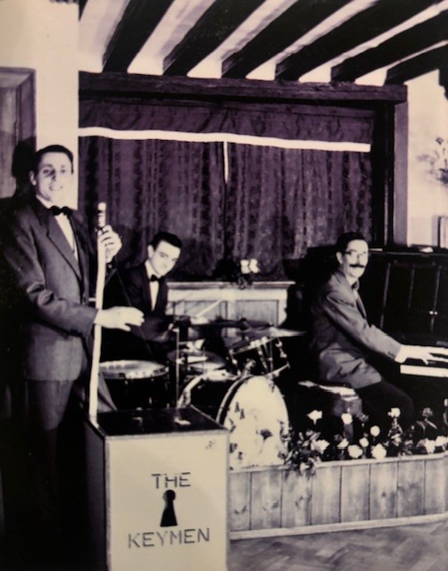 Three men playing instruments onstage