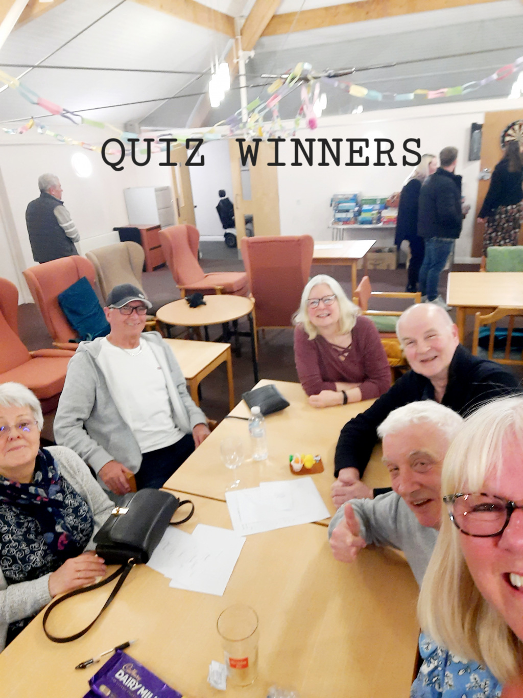 Group of elderly people sitting around the table