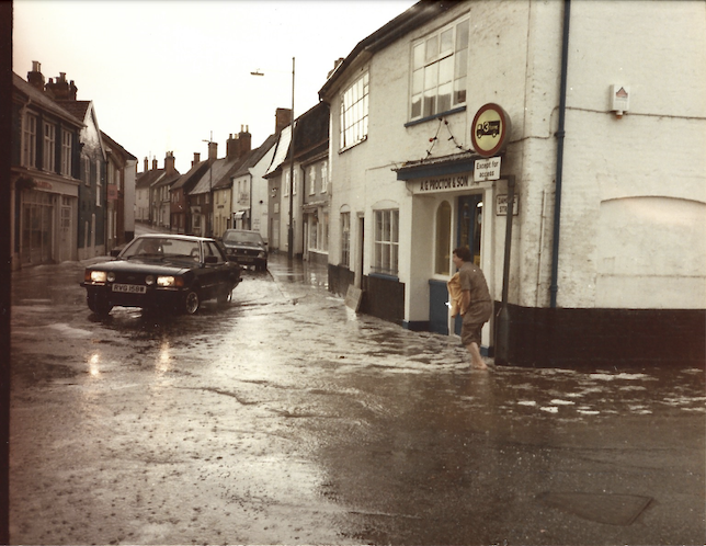 A car driving through a flooded street