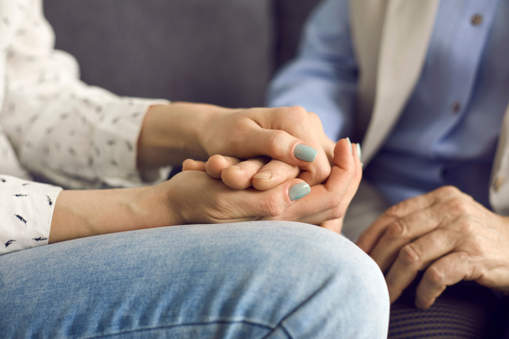 Closeup of two women holding hands