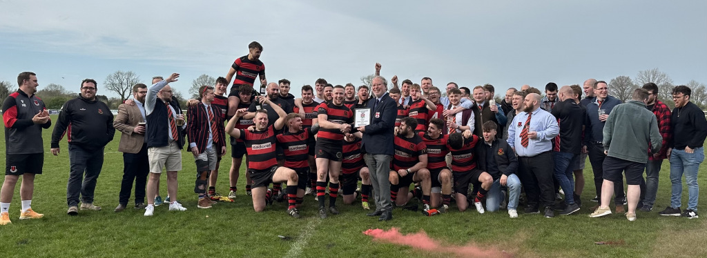 rugby team celebrates with trophy